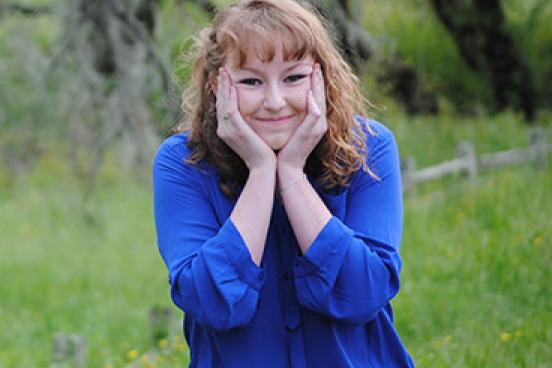 Woman with a blue shirt, smiling