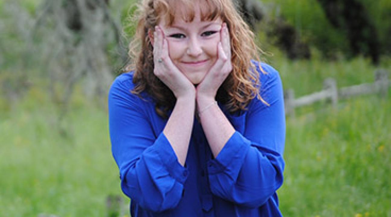 Woman with a blue shirt, smiling