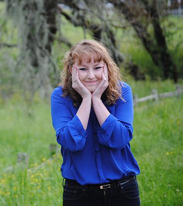 Woman with a blue shirt, smiling