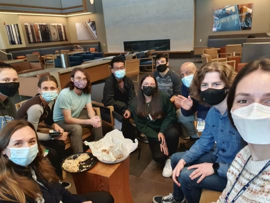 Student gathered in lunch group, wearing protective masks